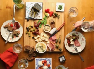 tapas board surounded by two dishes with food