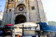White, orange and blue tuk tuk in front of Sé Cathedral in Lisbon