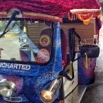Front view of a tuk tuk decorated for the release of the game Uncharted: The Lost Legacy