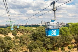 Cable cars going through the city of Madrid
