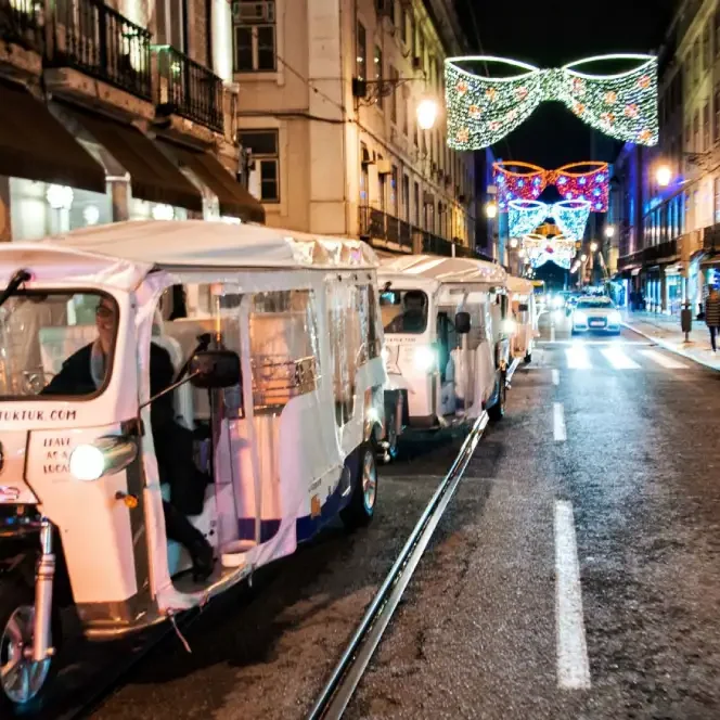 lisbon christmas lights tuk tuk in an lisbon street with christmas decorations