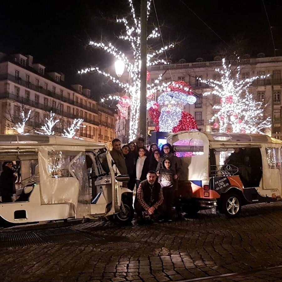 vouchers christmas Group of people in front of two tuk tuk with Christmas decorations in the background