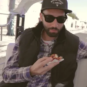 men eating a custard tart inside a tuk tuk