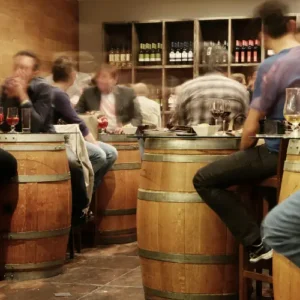 group of people tasting wines in a cellar